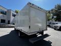 A 2021 Ford Econoline cargo van with a white exterior and a flat loading area at the rear
