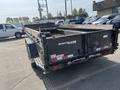 A 2024 Southland SL716-20K trailer featuring a black body with a flatbed design and a tailgate in the lowered position