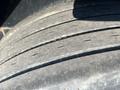 A close-up view of a worn tire showcasing visible tread wear on a 2020 Load Trail 28 Foot Gooseneck trailer tire
