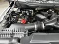 Engine compartment of a 2020 Ford F-350 SD showing various components like the air intake system battery and wiring