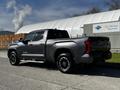A 2023 Toyota Tundra in gray color parked at an angle showcasing its modern design and chrome accents