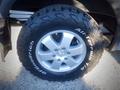 A close-up of a silver wheel on a 2017 Mercedes-Benz Sprinter featuring rugged BFGoodrich All-Terrain tires with a distinctive tread pattern