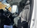 A 2017 RAM Promaster interior showing two fabric front seats with a steering wheel and dashboard visible