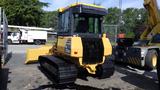 A yellow 2013 Komatsu D37PX-22 bulldozer with a front blade and rubber tracks positioned on a work site