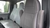 A gray interior of a 2005 International 4300 featuring two spacious and ergonomic seats with a high back design