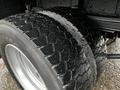 Close-up of the dual rear tires of a 2005 GMC C5 Duramax showcasing deep treads and a shiny silver rim