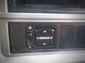 Control panel for adjusting side mirrors in a 2013 Hino 308 with a directional switch and a dial for left and right adjustments