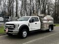 A 2018 Ford F-550 with a tanker attachment featuring a metallic body and red hazard markings on the side