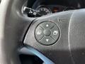 Close-up of the steering wheel controls of a 2017 Mercedes-Benz Sprinter featuring a directional pad and buttons for adjustments