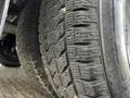 Close-up of the tread on a tire mounted on a 2013 Chevrolet Express showing deep grooves and texture for traction