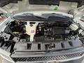 The image shows the engine bay of a 2018 Chevrolet Express with various components including an engine block battery and fluid reservoirs