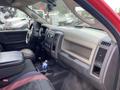 Interior view of a 2012 RAM 2500 truck showing the dashboard steering wheel front seats and center console with a bottle of water on top