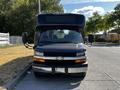 A 2019 Chevrolet Express van in black with a silver front grille and headlights facing forward