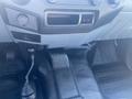 Interior view of a 2014 Ford F-250 SD showing the dashboard gear shifter and floor area with textured mats and a console control panel