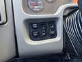 Control panel of a 2018 International DuraStar featuring buttons for mirror adjustment light controls and panel settings