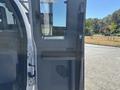 Interior view of a 2016 Ford F-550 showing the driver's side door including the window controls and seatbelt system