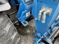 Close-up of a 2020 Genie GTH-5519 telehandler showing the hydraulic connections and tire tread on the rear left side