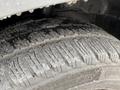 Close-up of a worn tire tread on a 2017 Ford Transit showing deep grooves and debris on the surface