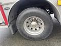 A close-up view of the large tire and wheel of a 2006 E-One Typhoon fire truck showing the tread and rim design