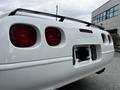 Rear view of a white 1992 Chevrolet Corvette with distinctive round taillights and a sleek design