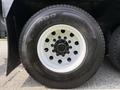 Close-up view of a white and black wheel of a 1996 Kenworth T800 featuring a five-bolt pattern and rugged tread on a heavy-duty tire