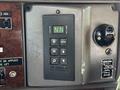 Close-up of the control panel in a 2009 Kenworth T270 featuring buttons for gear selection and a monitor display