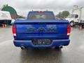 A blue 2019 RAM 1500 Classic truck viewed from the rear showcasing the RAM logo and dual exhaust pipes