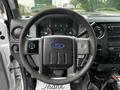 Steering wheel and dashboard of a 2011 Ford F-550 displaying gauges and controls