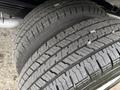 Close-up of three tires with deep treads designed for a 2022 Ford E-450 showcasing their textured surface and grip pattern