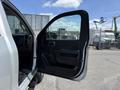 A 2016 Chevrolet Silverado 2500HD with the driver's side door open showcasing the interior features and door panel design