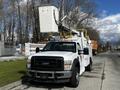 A 2008 Ford F-550 truck with a raised aerial lift and utility equipment mounted in the truck bed