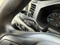 Close-up of the steering wheel controls and dashboard of a 2022 Ford Transit showing turn signal and other control buttons