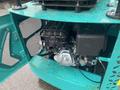 A 2024 AGT Industrial MH12R Mini Excavator with its engine compartment open displaying the engine and mechanical components inside