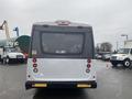 Rear view of a white 2018 Chevrolet Express with red brake lights and reflective strips