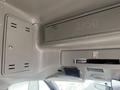 Interior view of a 2012 Chevrolet Express showing overhead storage compartments and a dashboard with electronic controls