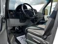 Interior view of a 2012 Mercedes-Benz Sprinter showing the driver's seat and dashboard with controls and steering wheel