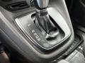 The gear shifter of a 2014 Ford Transit Connect with markings for park reverse neutral drive and sport mode