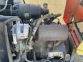 Close-up of the engine assembly of a 2010 Kubota F3680 featuring the alternator and various hoses connected to the engine components