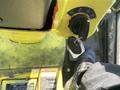 Close-up of the ignition switch and key for a 2010 Kubota F3680 with a portion of the operator's foot on a pedal beside it