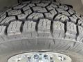 Close-up of a rugged tire tread on a 2012 GMC Savana showing deep grooves and a sturdy design for traction and durability