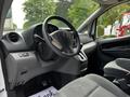 Interior of a 2020 Nissan NV200 showing the steering wheel dashboard and front seats
