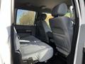 The interior of a 2016 Ford F-550 showing a spacious rear bench seat with gray upholstery and minimalist design