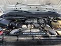 Engine compartment of a 2008 Ford F-450 SD featuring a Power Stroke V8 turbo diesel engine with various components including air intake and coolant reservoir