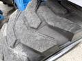 Close-up of a treaded tire from a 2020 Genie GTH-5519 featuring deep grooves and a rugged surface designed for traction in various terrains