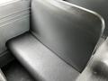 A black vinyl seat inside a 2015 Spartan School Bus