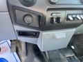 Close-up of the dashboard controls in a 2015 Ford F-450 SD showing various buttons and a port for accessories