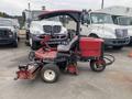 A 2011 Toro Reelmaster 3100-D turf mower with a red body and a protective canopy designed for maintaining golf courses and sports fields