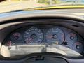 Dashboard of a 2003 Ford Mustang featuring speedometer RPM gauge fuel gauge and various indicator lights