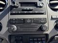 Dashboard controls of a 2012 Ford F-350 SD including air conditioning settings radio buttons and auxiliary inputs