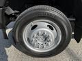 Close-up of a silver alloy wheel with a tire labeled Conti Hybrid HD3, designed for a 2021 Ford F-550, showcasing a multi-spoke pattern and tire tread detail
